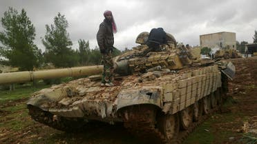 Free Syrian Army fighters inspect a tank after the fighters said they fought and defeated government troops in Al-Latameneh, near Hama December 22, 2012. 