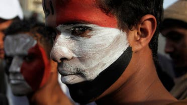 Pro-democracy protesters, with their faces painted in the colours of Yemen's national flag, look on during a demonstration to mark the anniversary of an uprising against former president Ali Abdullah Saleh in Sanaa February 8, 2014. reuters