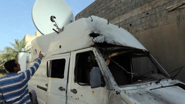 A damaged satellite van belonging to the Libyan Alasseman television station after its premises were attacked overnight with rocket-propelled grenades. (AFP)