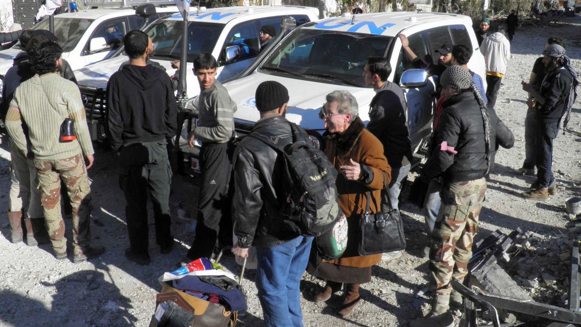 Civilians evacuate from a besieged area of Homs
