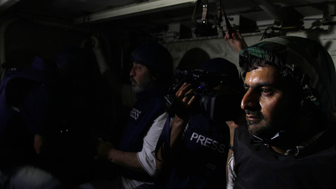 Journalists sit in an army soldier’s carrier on their way to the front line, during a guided tour by the Syrian Army in the Damascus suburb of Jobar, on August 24, 2013. (File photo: Reuters)
