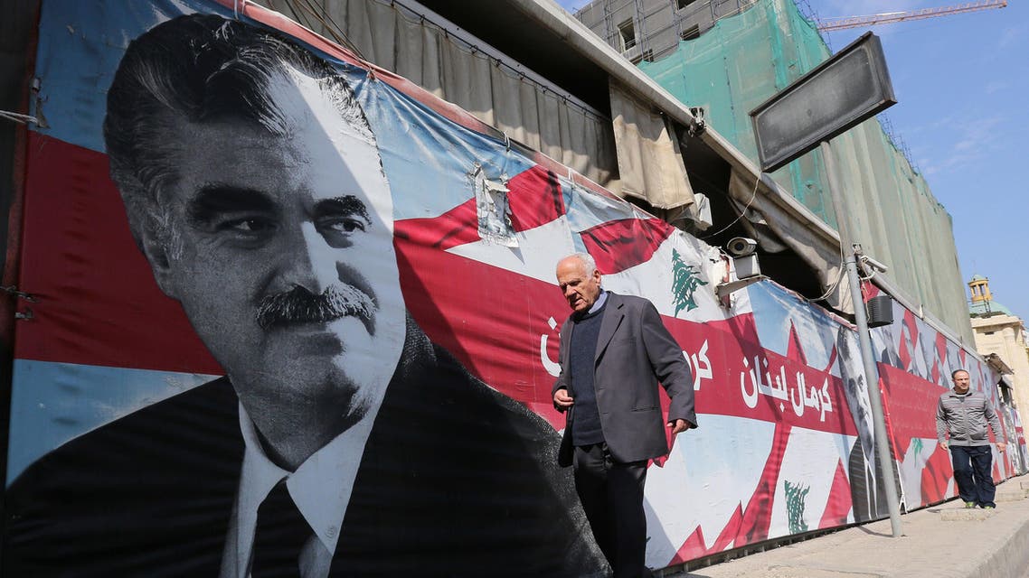 A man walks past a portrait of slain Lebanese premier Rafiq Hariri on the ninth anniversary of his death on February 14, 2014. AFP