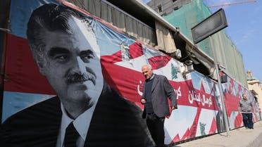  A man walks past a portrait of slain Lebanese premier Rafiq Hariri on the ninth anniversary of his death on February 14, 2014. AFP