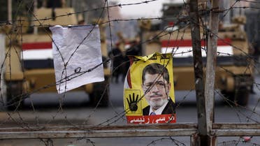 A poster of ousted Egyptian President Mohamed Mursi is pictured on barbed wires during a protest Reuters 