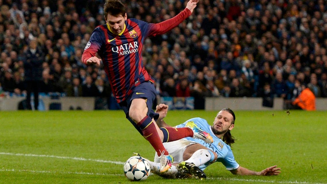 Manchester City's Martin Demichelis (R) fouls Barcelona's Lionel Messi to concede a penalty during their Champions League round of 16 first leg soccer match at the Etihad Stadium in Manchester, northern England Feb. 18, 2014.  (Reuters)