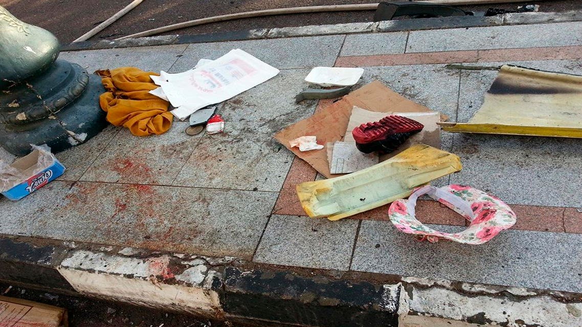 A shoe is seen on a pavement covered with blood in the Red Sea resort town of Taba in the south Sinai, February 16, 2014. An explosion on a tourist bus in Egypt's Sinai peninsula killed three Koreans and the Egyptian driver