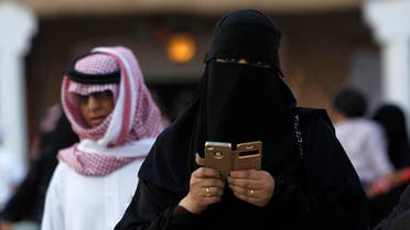 A woman using an iPhone visits the 27th Janadriya festival on the outskirts of Riyadh February 13, 2012. 