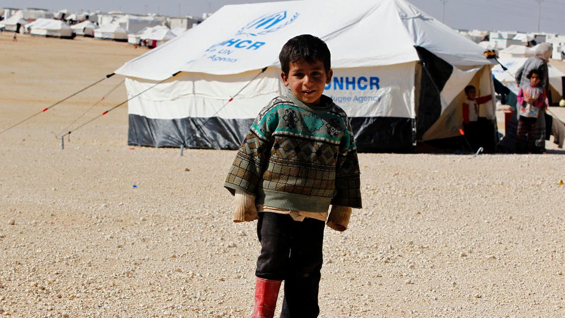 A Syrian refugee boy stands outside his tent at Al Zaatri refugee camp in the Jordanian city of Mafraq, near the border with Syria, February 18, 2014. (Reuters)