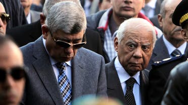 Egypt's Interior Minister Mohamed Ibrahim (L) and Prime Minister Hazem el-Beblawi 
