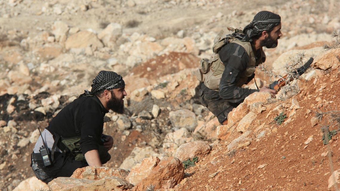 Rebel fighters take cover during reported battles against pro-government forces on February 23, 2014, in the Sheikh Najjar district on the outskirts of the northern Syrian city of Aleppo. AFP