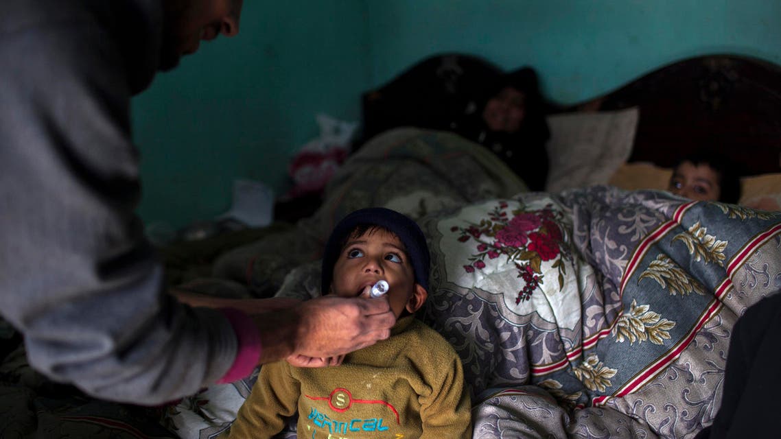 A polio worker gives polio vaccine drops to a child in Islamabad February 26, 2014. reuters