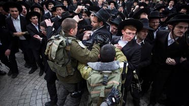 Israeli border policemen scuffle with ultra-Orthodox Jewish protesters during a demonstration in Jerusalem Feb. 6, 2014. (Reuters)