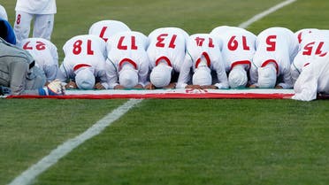The Iranian women's national soccer team pray after withdrawing from their qualifying match against Jordan for the 2012 London Olympic Games reuters