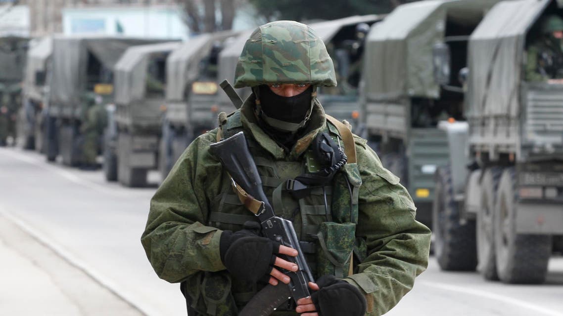 Armed servicemen wait in Russian army vehicles outside a Ukranian border guard post in the Crimean town of Balaclava March 1, 2014. reuters