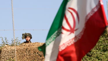 An Iranian flag flies in front of the Israel-Lebanon border at Kfar Kila village in south Lebanon May 24, 2010. 