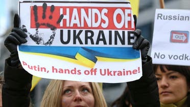 People gather outside an European Union emergency foreign ministers meeting to protest against Russian troops in Ukraine, in Brussels, March 3, 2014. (Reuters)