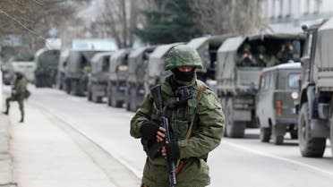 Armed servicemen wait in Russian army vehicles outside a Ukrainian border guard post in the Crimean town of Balaclava on March 1. (Reuters)