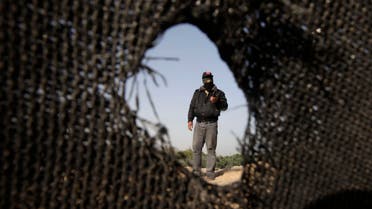 A Palestinian militant of the Democratic Front for the Liberation of Palestine (DFLP) inspects a training base after it was hit by an Israeli air strike in Rafah in the southern Gaza Strip April 28, 2013 
