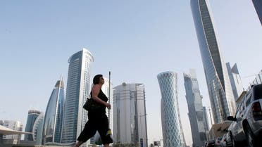 A woman crosses the street in Doha near the headquarters of some of Qatar’s biggest firms. (File photo: Reuters)