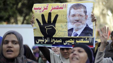 Supporters of Muslim Brotherhood and ousted Egyptian President Mohamed Mursi shout slogans against the military and the interior ministry as they gesture with the sign "Rabaa", or "Four", during a protest around Ain Shams square in east Cairo February 14, 2014. reuters