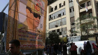 People walk past a huge banner for Egypt's army chief, Field Marshal Abdel Fattah al-Sisi in downtown Cairo, March 4, 2014. (Reuters)