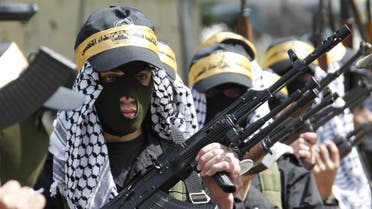 Palestinian Fatah members carry their weapons as they take part in a parade to mark the 65th anniversary of Nakba, at Ain al-Hilweh Palestinian refugee camp. (Reuters)