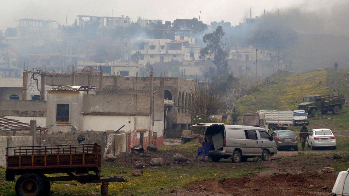 A handout picture released by the official Syrian Arab News Agency (SANA) shows smoke billowing from houses in the town of Zara, in the province of Homs, on March 8, 2014. (AFP)