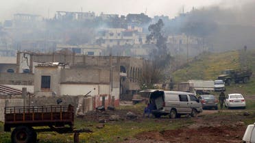  A handout picture released by the official Syrian Arab News Agency (SANA) shows smoke billowing from houses in the town of Zara, in the province of Homs, on March 8, 2014. (AFP)