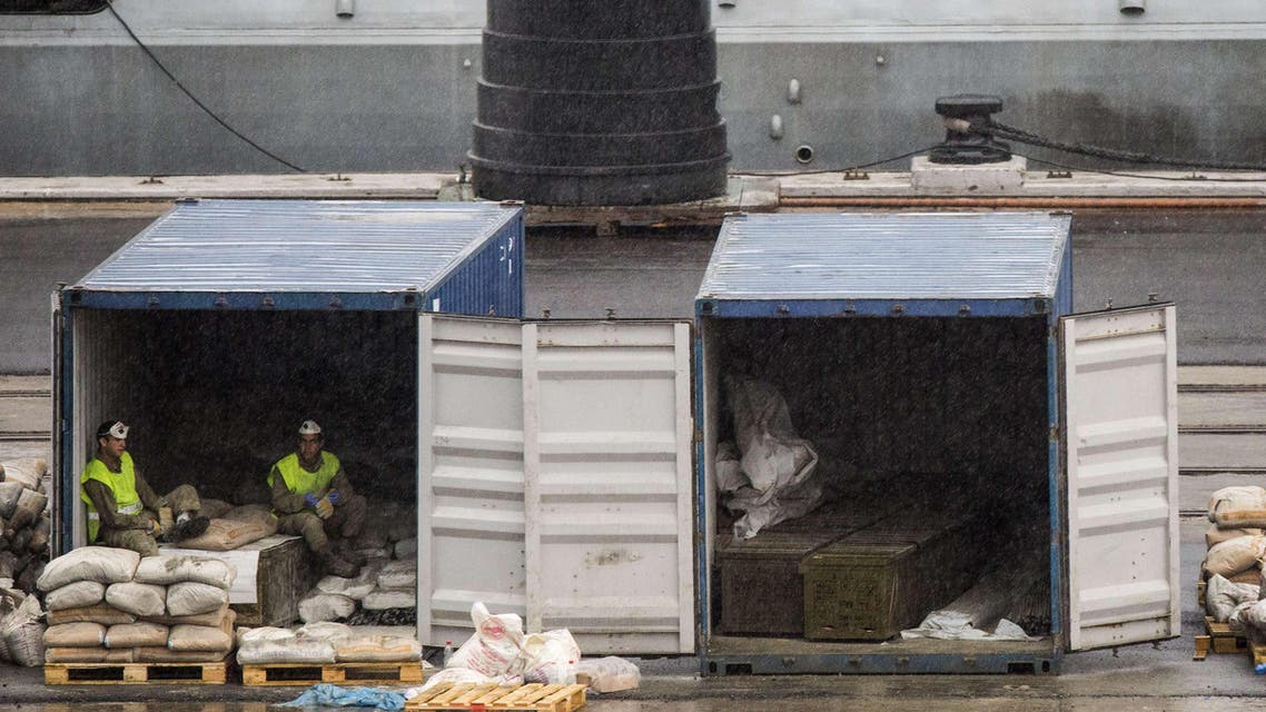 Israeli soldiers sit on crates said to contain M-302 rockets that were unloaded from the Panamanian-flagged Klos-C vessel on March 9, 2014 in the southern Israeli port of Eilat.