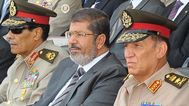 Former armed forces chief Sami Anan, right, with ousted President Mohammad Mursi, center, and former defense minister Mohammed Hussein Tantawi, left, attending a graduation ceremony of military cadets in Cairo. (File Photo: AFP)