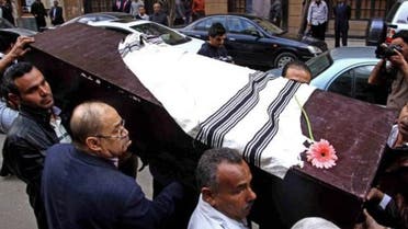 Egyptians carry the coffin of Nadia Haroun, the deputy head of the dwindling Jewish community, outside the Jewish synagogue, Shaar Hashamayim, in Cairo, Egypt on Tuesday, March 11, 2014.