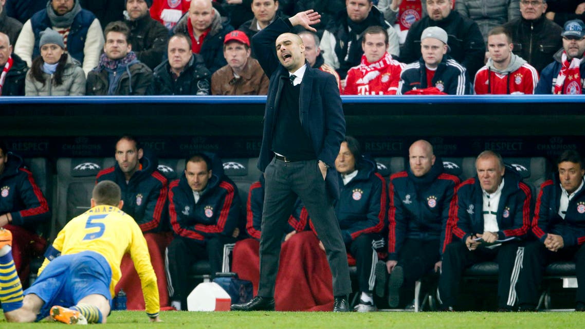 Bayern Munich's coach Pep Guardiola reacts during their Champions League round of 16 second leg soccer match against Arsenal in Munich, March 11, 2014.