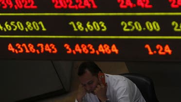 A trader speaks on his mobile phone next to a stock index board at the Egyptian Stock Exchange in Cairo on June 7, 2012. (File photo: Reuters)