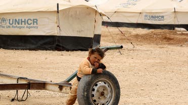 A Syrian refugee child plays at Alzaatri Syrian refugee camp in the Jordanian city of Mafraq, near the border with Syria