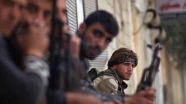 A Free Syrian Army sits with his fellow fighters in the town of Morek in Hama province March 11, 2014. (Reuters)