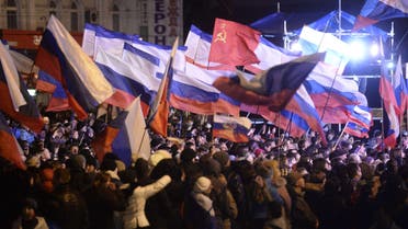  Pro-Russian Crimeans wave Russian flags as they gather to celebrate in Simferopol's Lenin Square on March 16, 2014. (AFP)