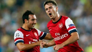 Arsenal midfielder Aaron Ramsey celebrates with teammate Santi Cazorla after scoring against Fenerbahce in their Champions League playoff first leg, August 21(Photo : Reuters) "