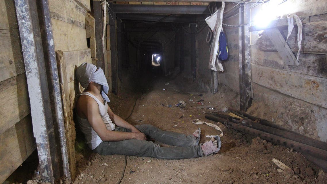 A tunnel worker rests inside a smuggling tunnel dug beneath the Gaza-Egypt border in the southern Gaza Strip. (Reuters)