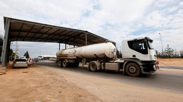 A tank truck exits from the main gate of the Zawiya refinery and oil port towards the local market, December 18, 2013. (Reuters)