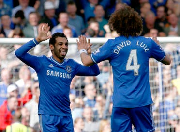 Chelsea's Mohamed Salah (L) celebrates with team mate David Luiz after scoring a goal against Arsenal during their English Premier League soccer match at Stamford Bridge in London, March 22, 2014. (Reuters)