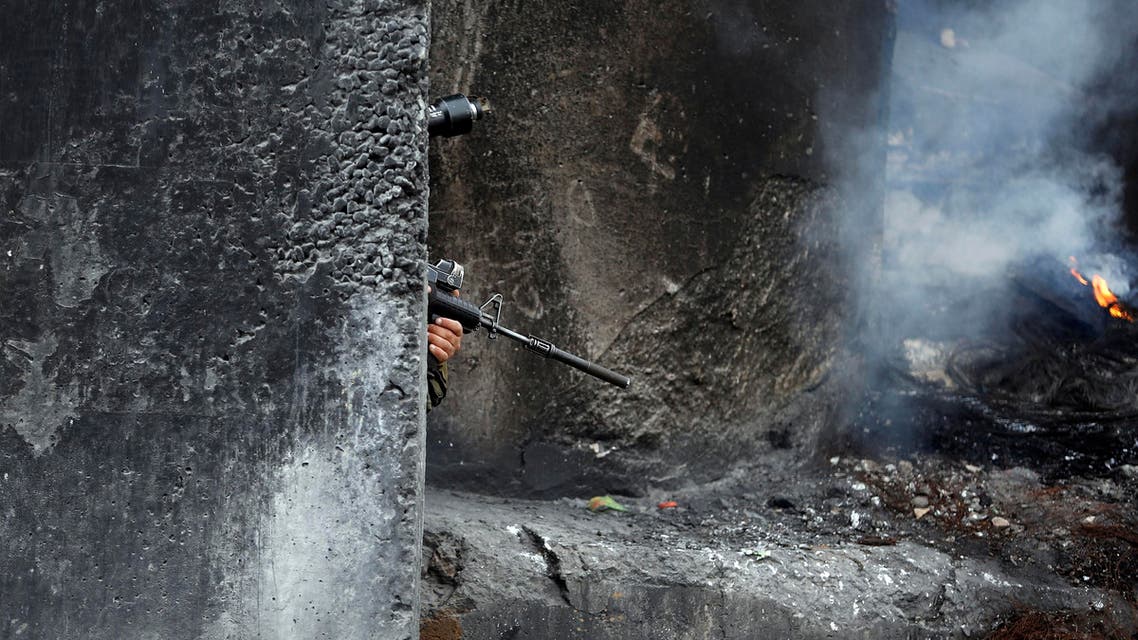 sraeli soldiers take up position during clashes with Palestinian stone-throwers following a rally marking International Woman's Day at Qalandiya checkpoint near the West Bank city of Ramallah March 8, 2014 euters