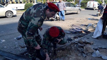 Lebanese army soldiers inspect a site of a roadside bomb, that exploded when the army was patrolling overnight the area in Tripoli, northern Lebanon March 21, 2014. (Reuters)