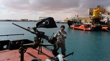 A rebel under Ibrahim Jathran holds the Cyrenaica flag while standing on a boat at Es Sider port in Ras Lanuf, where a North Korean-flagged tanker had loaded crude oil, March 11, 2014 reuters