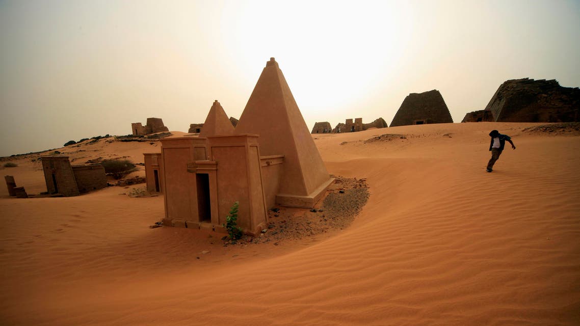 A boy plays near the site of 44 Nubian pyramids of kings and queens in the ruins of the ancient city of Meroe at Begrawiya reut