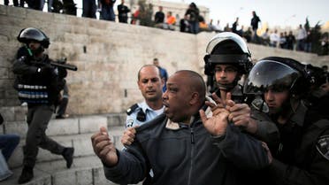 A Palestinian man is detained by Israeli border policemen during clashes near Damascus Gate at Jerusalem's old city March 22, 2014. reuters