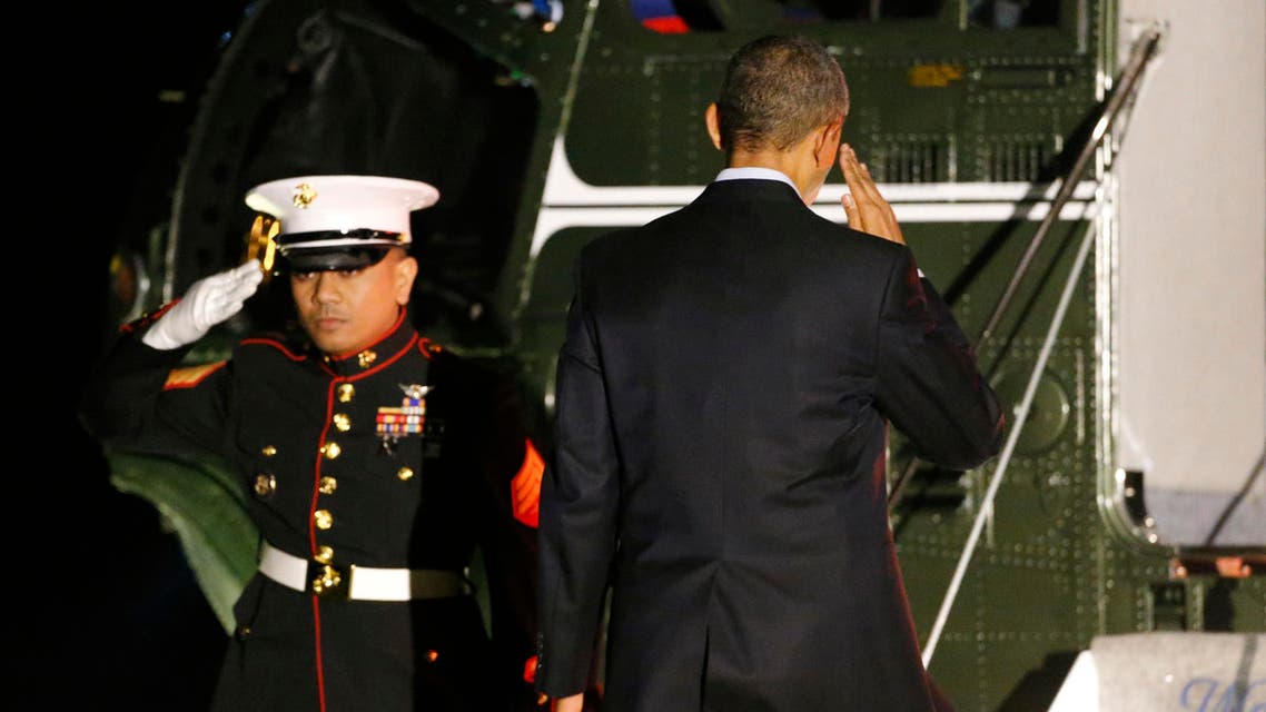 U.S. President Barack Obama (R) salutes as he boards Marine One to begin his travel to Europe from the White House in Washington March 23, 2014 reuters