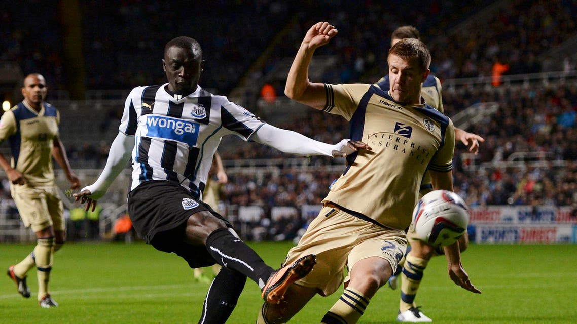 Newcastle United's Papiss Cisse (front L) is challenged by Leeds United's Scott Wootton (22) during their English League Cup soccer match at St James' Park in Newcastle, northern England September 25, 2013. (Reuters)