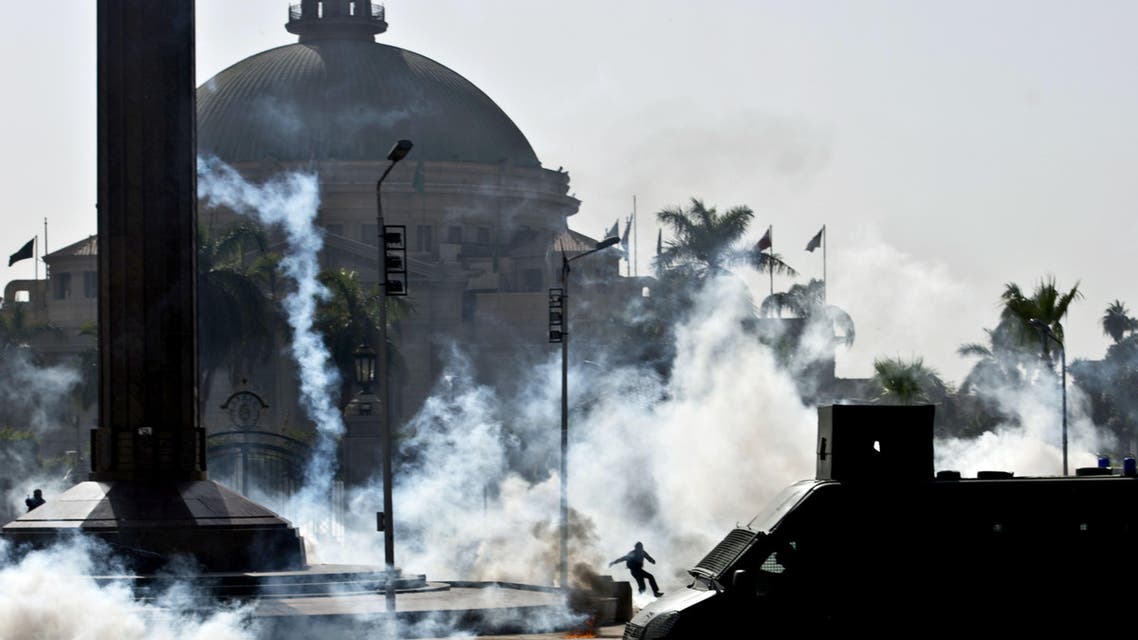 Egyptian students who support the Muslim Brotherhood and ousted Islamist President Mohammad Mursi run from tear gas fired by riot police during clashes following a demonstration outside Cairo University on March 26, 2014. (Reuters)