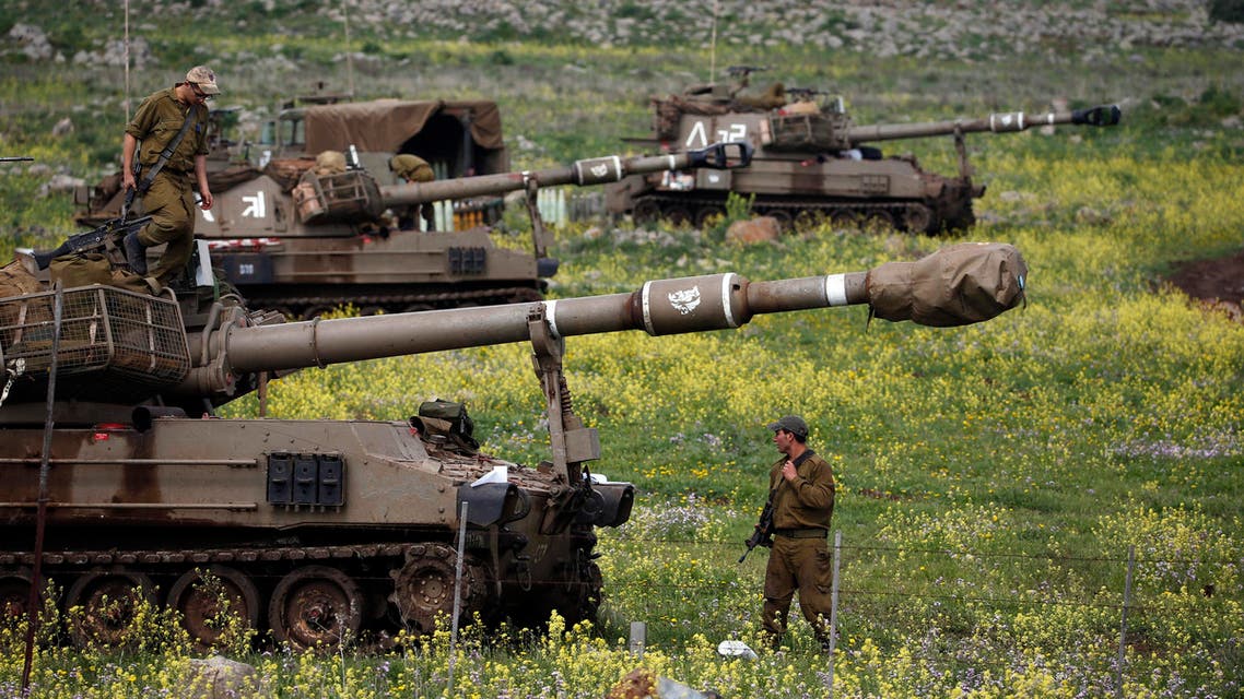 An Israeli soldier stands beside a mobile artillery unit near the town of Katzrin in the Golan Heights March 19, 2014. reuters