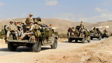Lebanese army soldiers on their military vehicles enter the Sunni Muslim border town of Arsal, in eastern Bekaa Valley March 19, 2014. (Reuters)